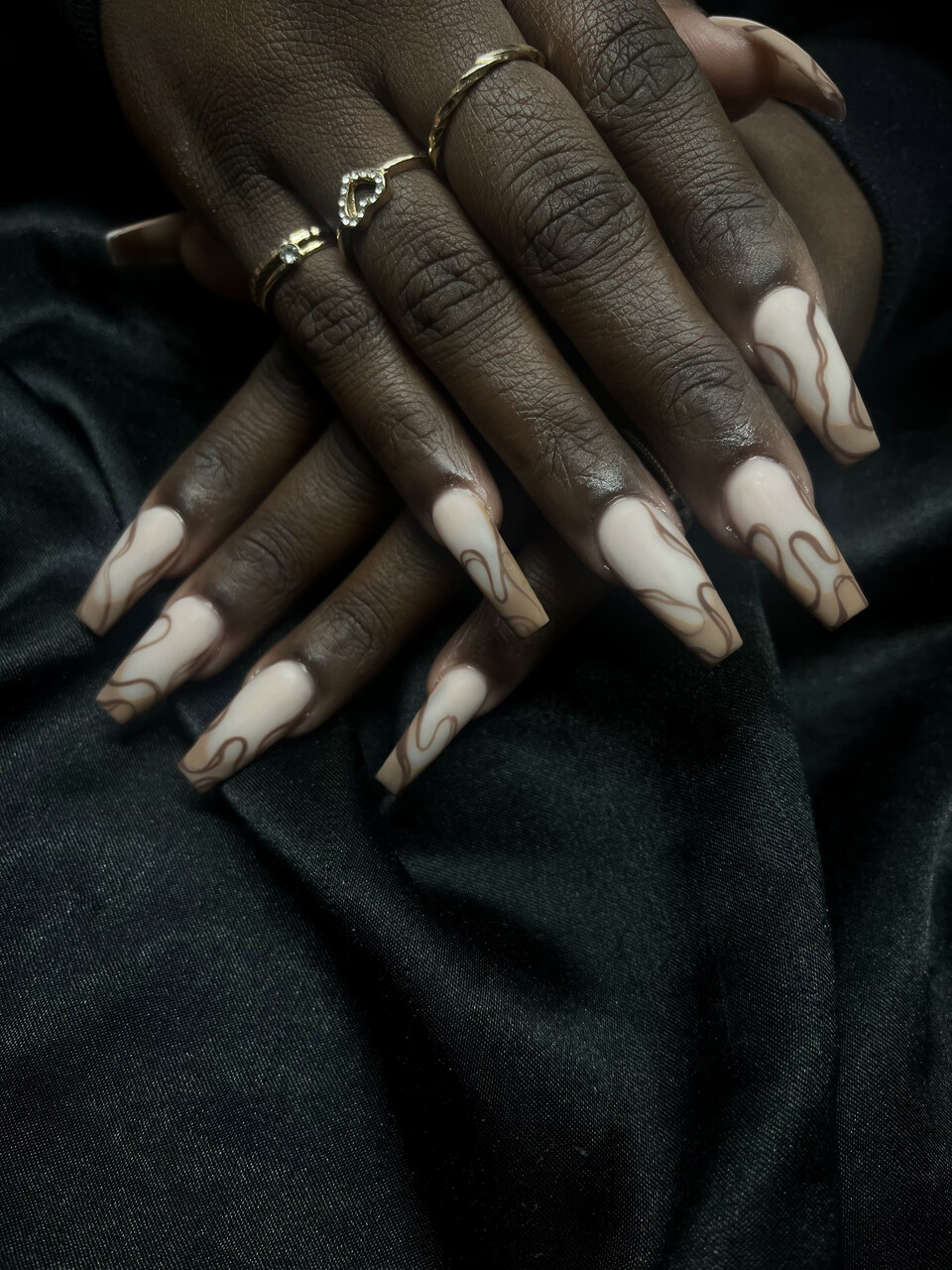 Cream coffin nails with brown swirl art on velvet