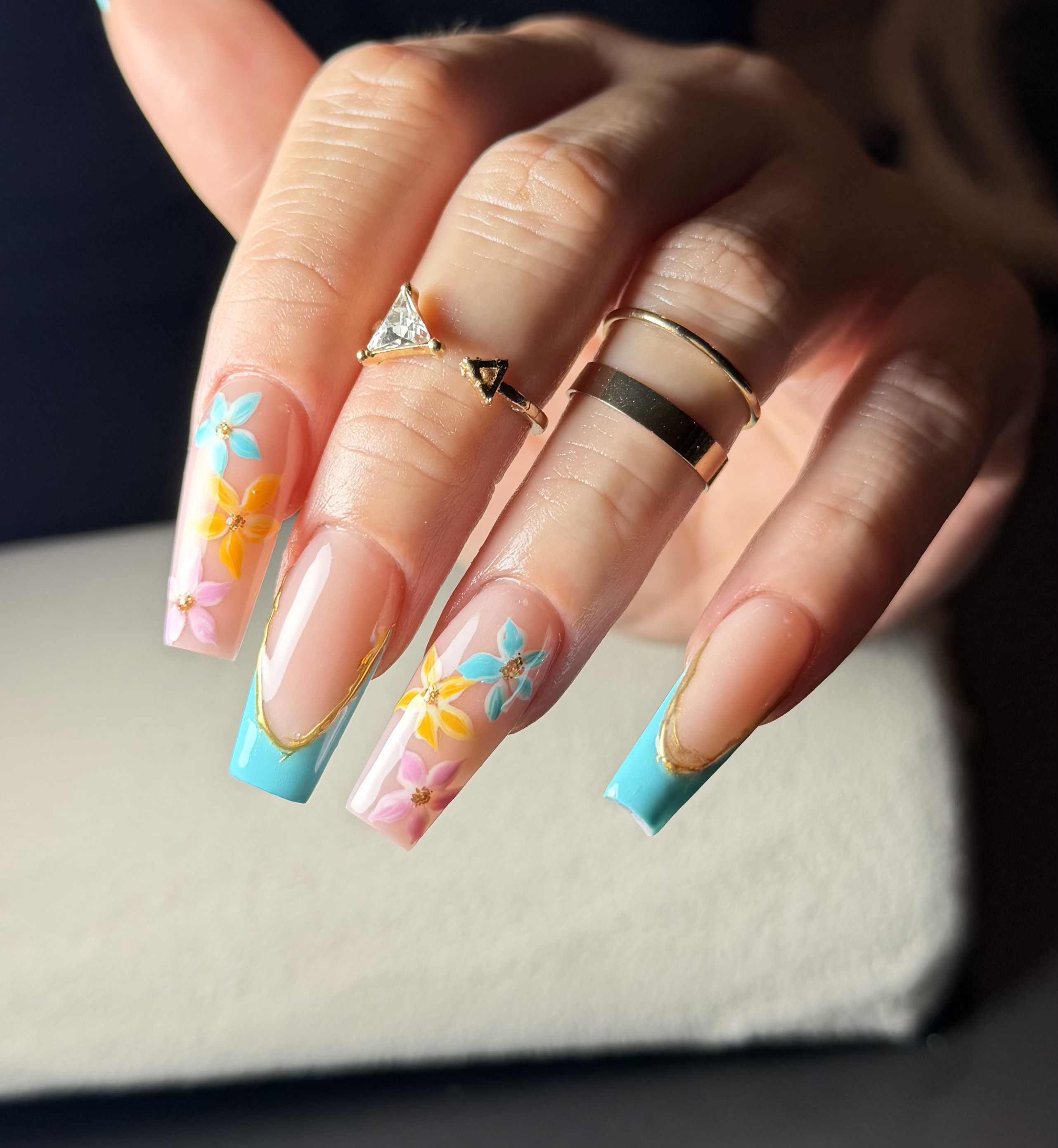 Nude coffin nails with blue French tip and floral art